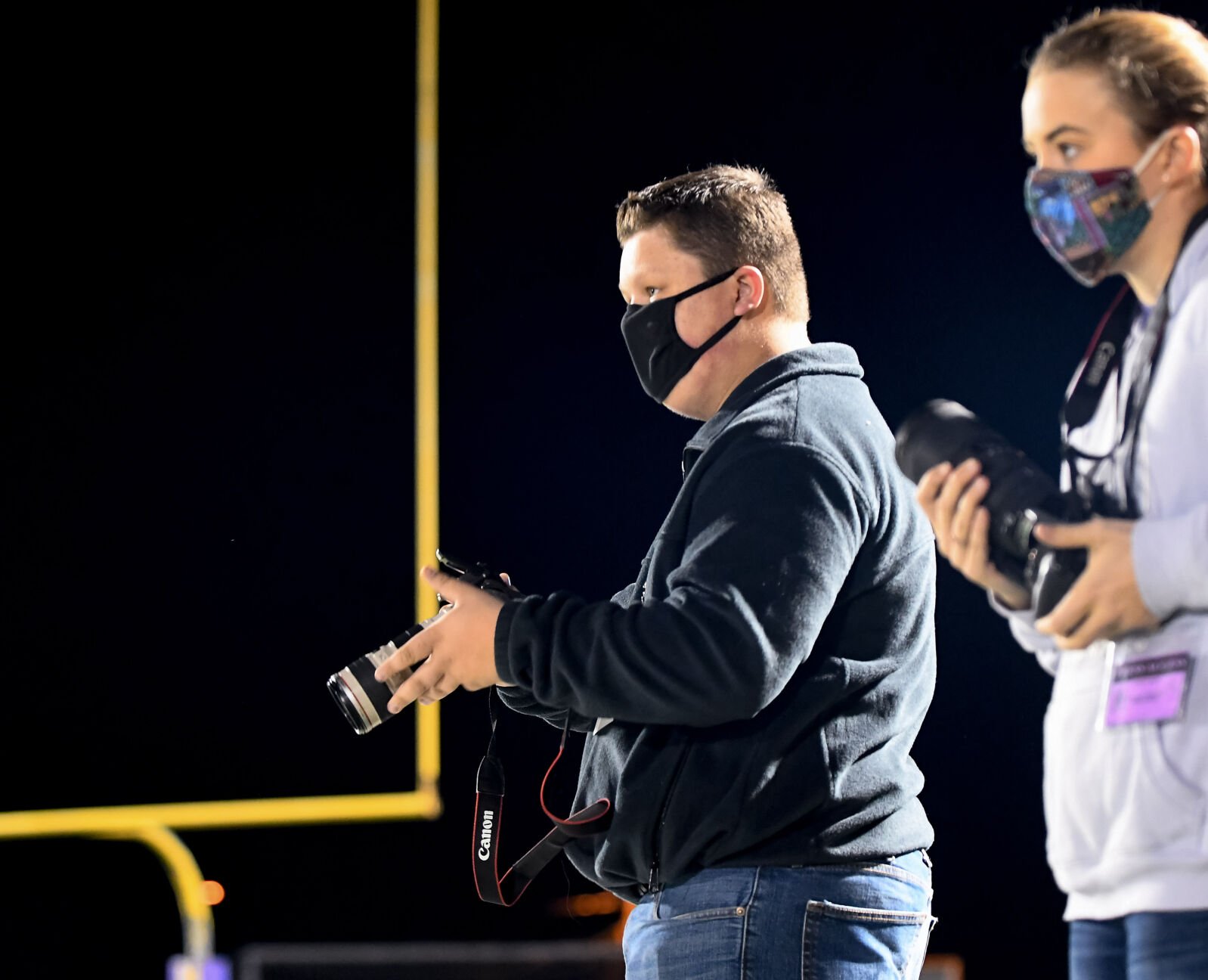 Hickman student journalist Bryce Robinson, left, eyes a play